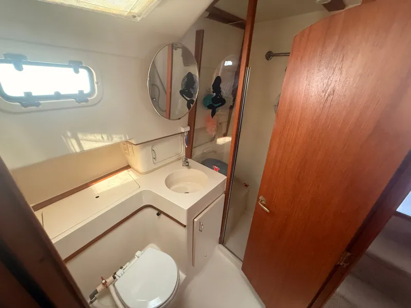 Slide: The Image of Bathroom interior of 2000 Mainship 390 Trawler with sink, toilet, and mirror. - 40