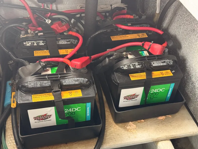 Slide: The Image of Batteries in a 2000 Mainship 390 Trawler engine compartment, featuring Interstate 24DC models. - 43