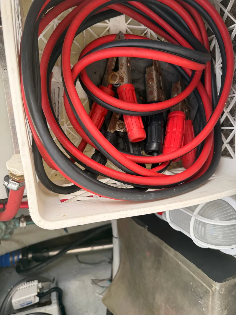 Slide: The Image of Red and black cables in a storage compartment on a 2000 Mainship 390 Trawler. - 49