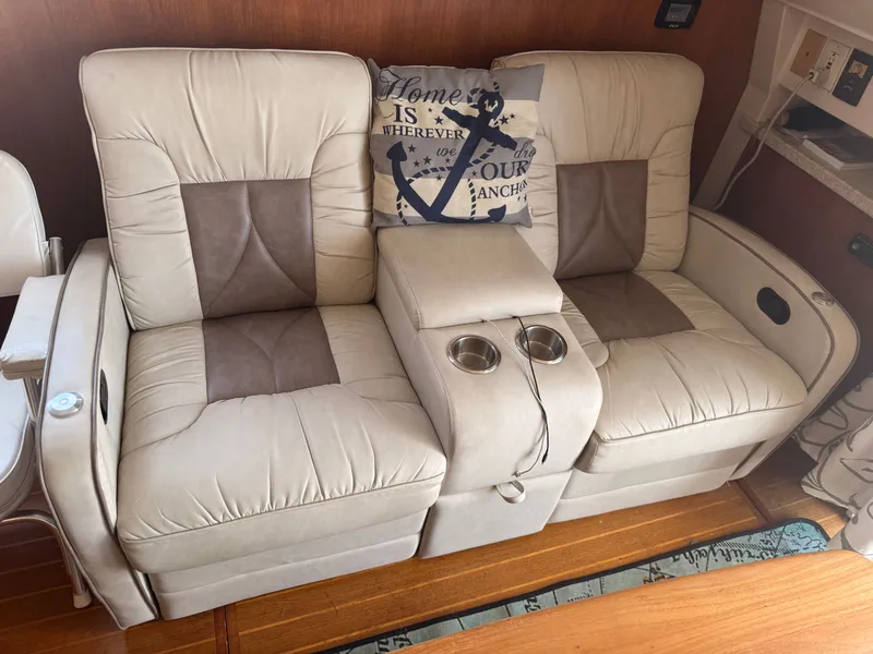 Slide: The Image of Beige leather seating with cup holders on a 2000 Mainship 390 Trawler boat. - 7
