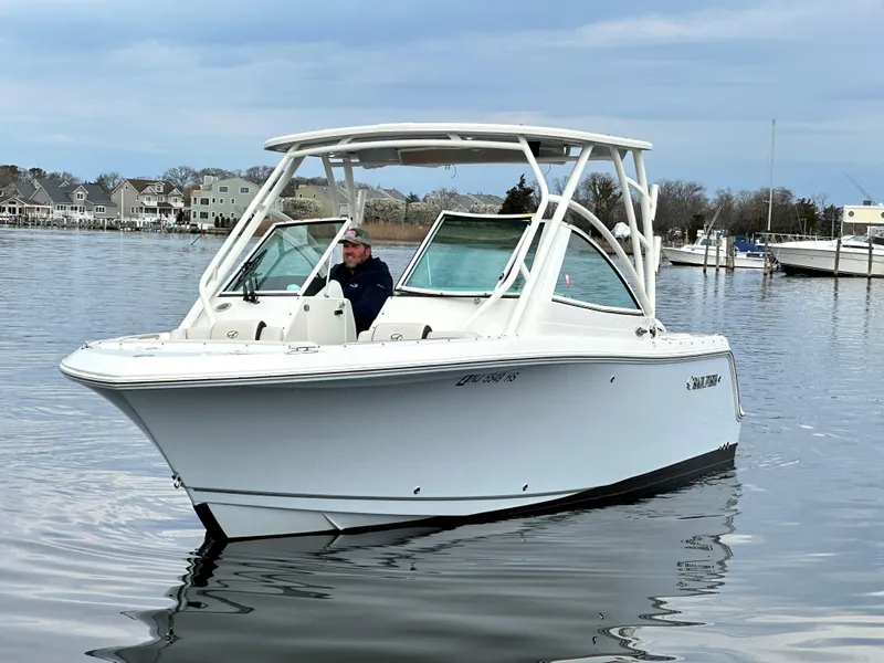 Slide: The Image of 2023 Sailfish 245 DC boat on calm water, featuring sleek design and modern amenities. - 10