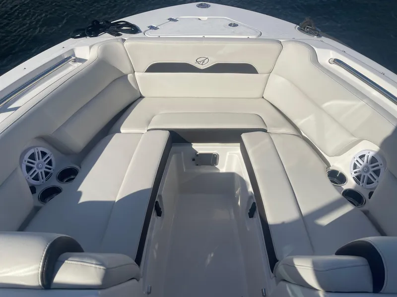 Slide: The Image of 2023 Sailfish 245 DC boat interior with cushioned seating and cup holders. - 12