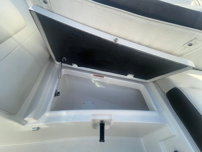 Slide: The Image of Open storage compartment on 2023 Sailfish 245 DC boat, showcasing interior space. - 18