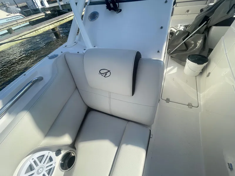 Slide: The Image of 2023 Sailfish 245 DC boat interior with white seating and speaker. - 20