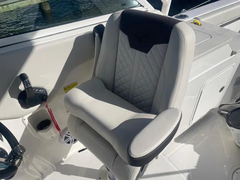 Slide: The Image of Captain's chair on 2023 Sailfish 245 DC boat, featuring ergonomic design and premium upholstery. - 30