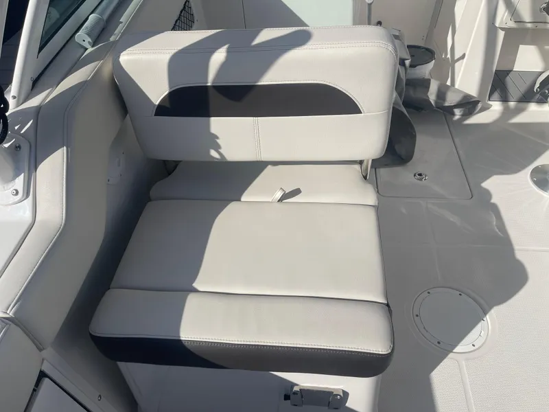 Slide: The Image of 2023 Sailfish 245 DC boat interior with cushioned seating and sleek design. - 32