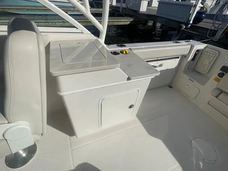 Slide: The Image of 2023 Sailfish 245 DC boat interior with seating and storage compartments. - 34