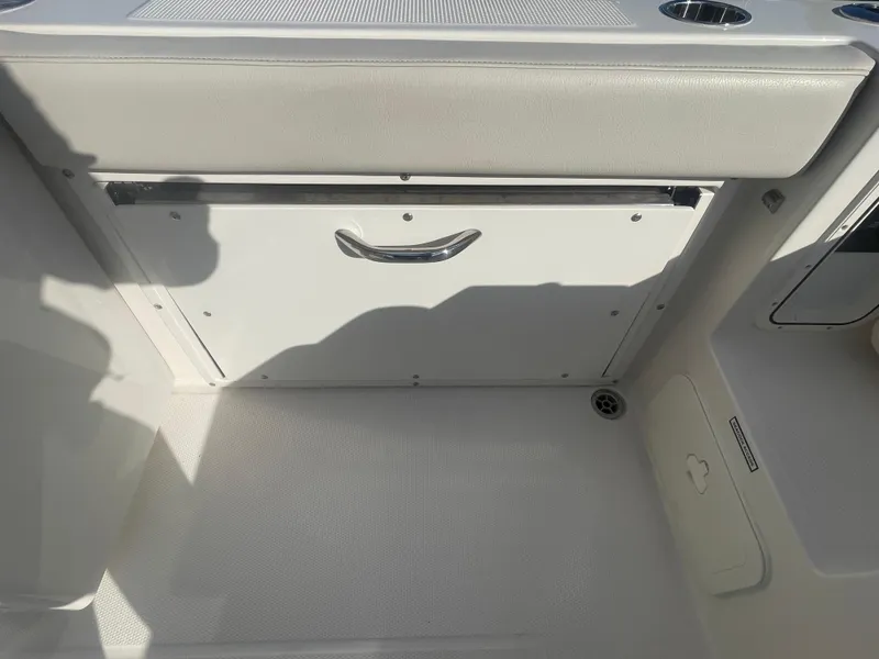 Slide: The Image of 2023 Sailfish 245 DC boat interior storage compartment with handle. - 36
