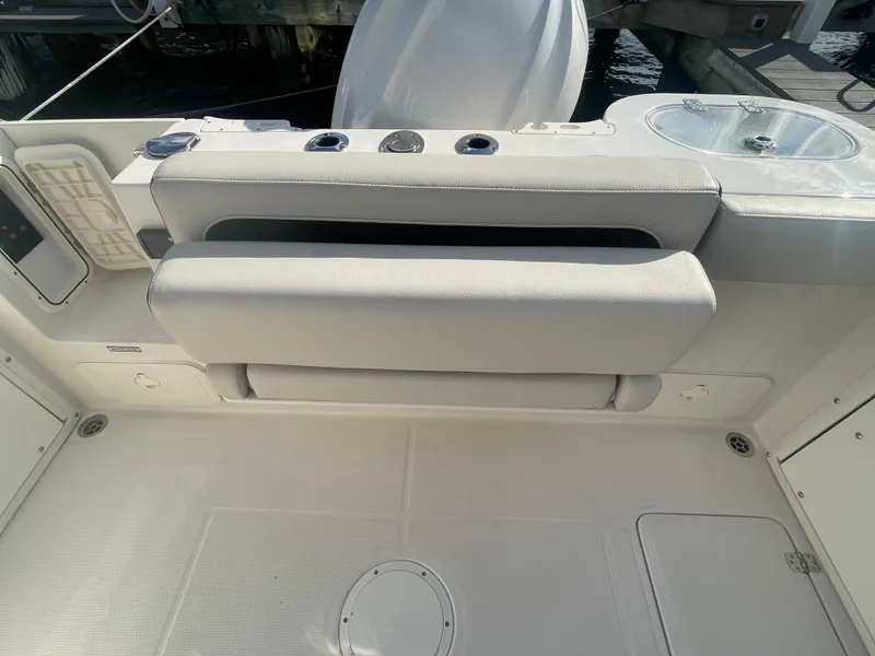 Slide: The Image of 2023 Sailfish 245 DC boat interior with cushioned seating and deck view. - 41