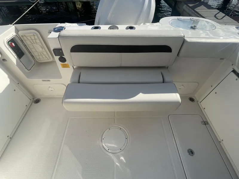 Slide: The Image of 2023 Sailfish 245 DC boat interior with foldable seating and storage compartments. - 42