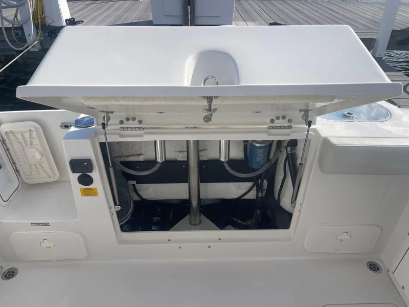 Slide: The Image of 2023 Sailfish 245 DC boat with open storage compartment on deck. - 43