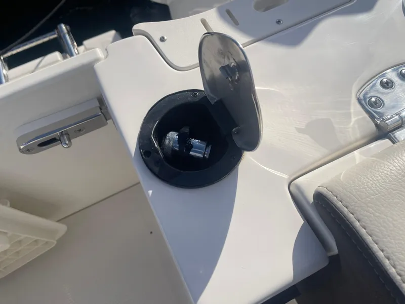 Slide: The Image of 2023 Sailfish 245 DC boat fuel cap with open cover in sunlight. - 47
