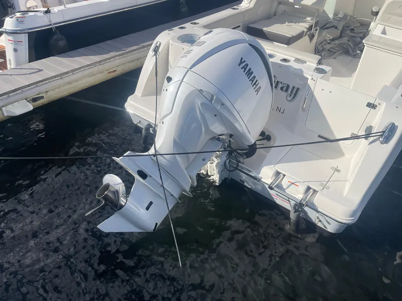 Slide: The Image of 2023 Sailfish 245 DC boat with Yamaha outboard motor docked at marina. - 52