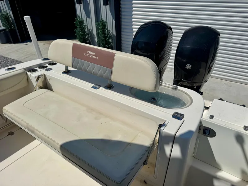 Slide: The Image of 2019 Cobia 261 boat with dual engines and cushioned seating. - 10