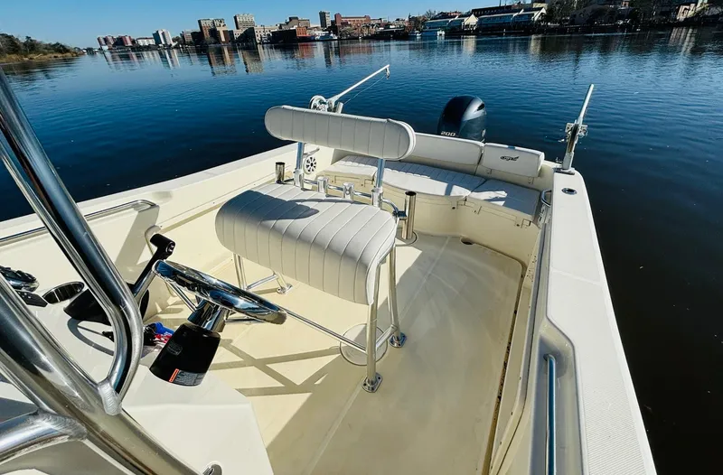 Slide: The Image of 2017 Bulls Bay 230 Center Console boat on calm water, cityscape in background. - 10