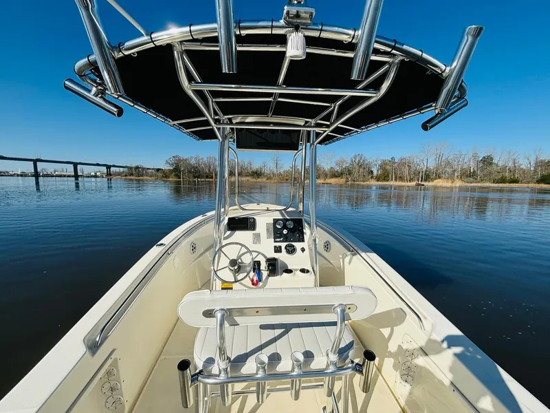Slide: The Image of 2017 Bulls Bay 230 Center Console boat on calm water, featuring a sleek design and spacious deck. - 11