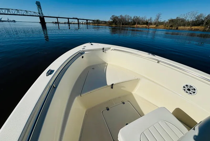 Slide: The Image of 2017 Bulls Bay 230 Center Console boat on calm water near a bridge. - 13