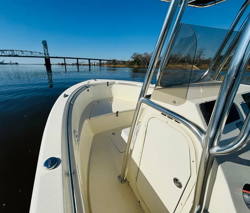 Slide: The Image of 2017 Bulls Bay 230 Center Console boat on calm water near a bridge. - 14