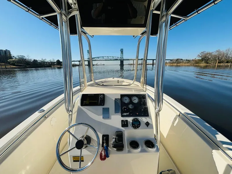 Slide: The Image of 2017 Bulls Bay 230 Center Console boat on calm river with bridge view. - 16