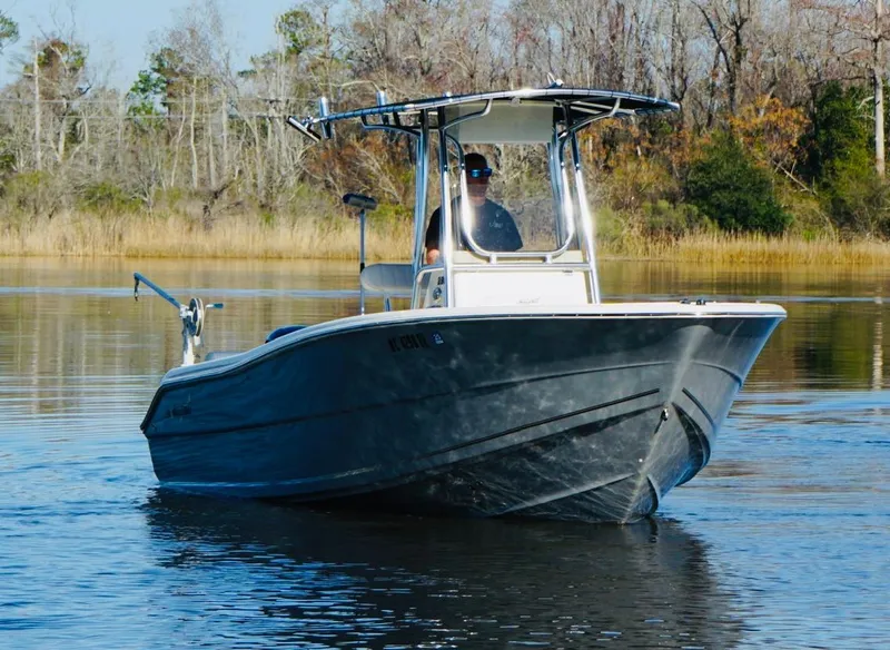 Slide: The Image of 2017 Bulls Bay 230 Center Console boat cruising on a calm lake. - 3
