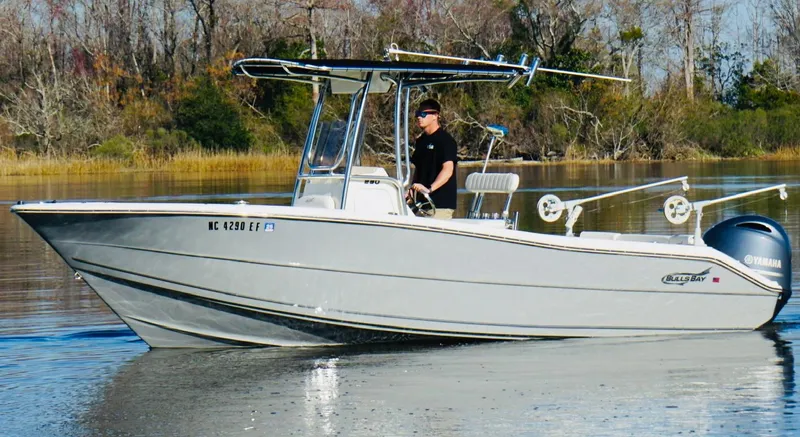 Slide: The Image of 2017 Bulls Bay 230 Center Console boat on calm water with driver. - 5