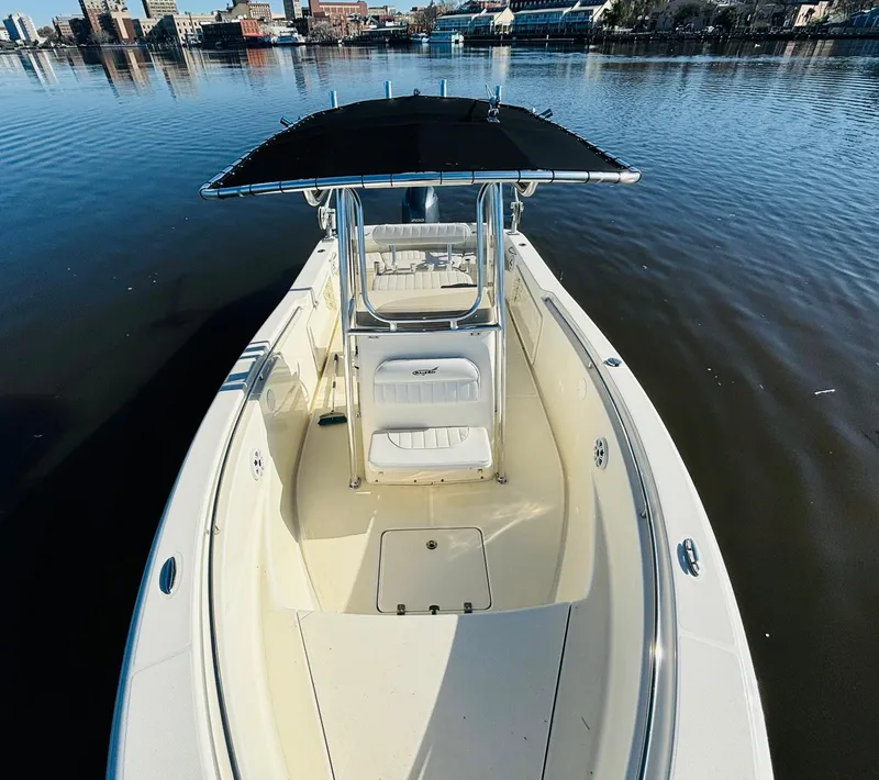Slide: The Image of 2017 Bulls Bay 230 Center Console boat on calm water, featuring a sleek design. - 6