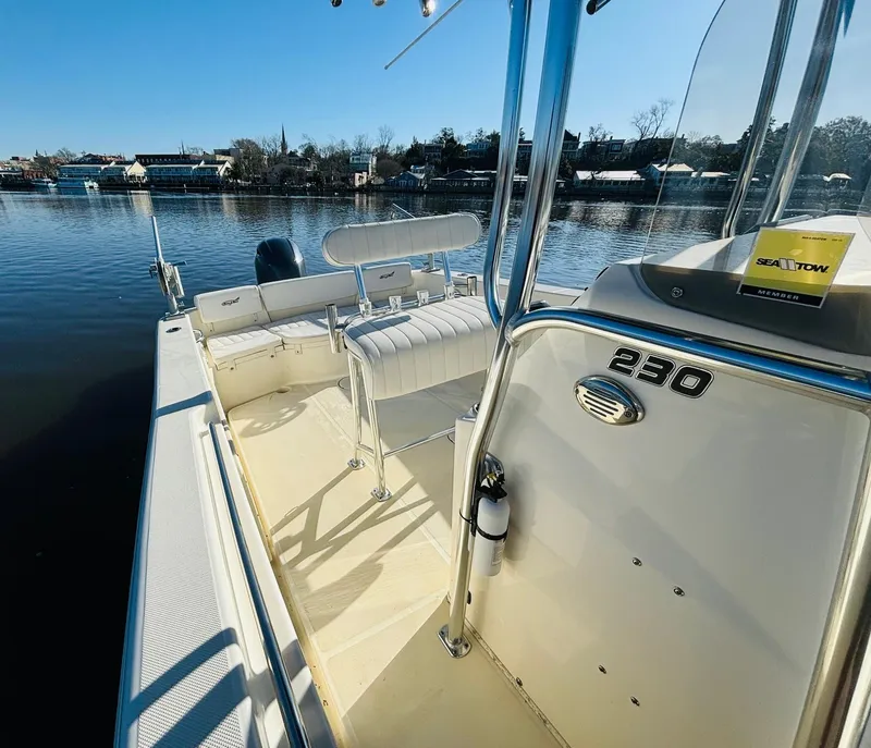 Slide: The Image of 2017 Bulls Bay 230 Center Console boat on calm water, showcasing interior seating and console. - 7