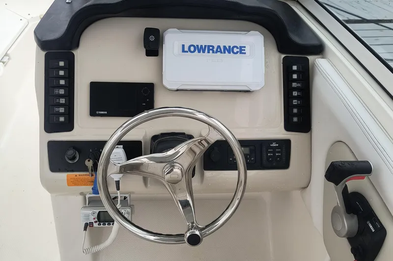 Slide: The Image of 2016 Robalo R247 Dual Console helm with Lowrance navigation system and steering wheel. - 14