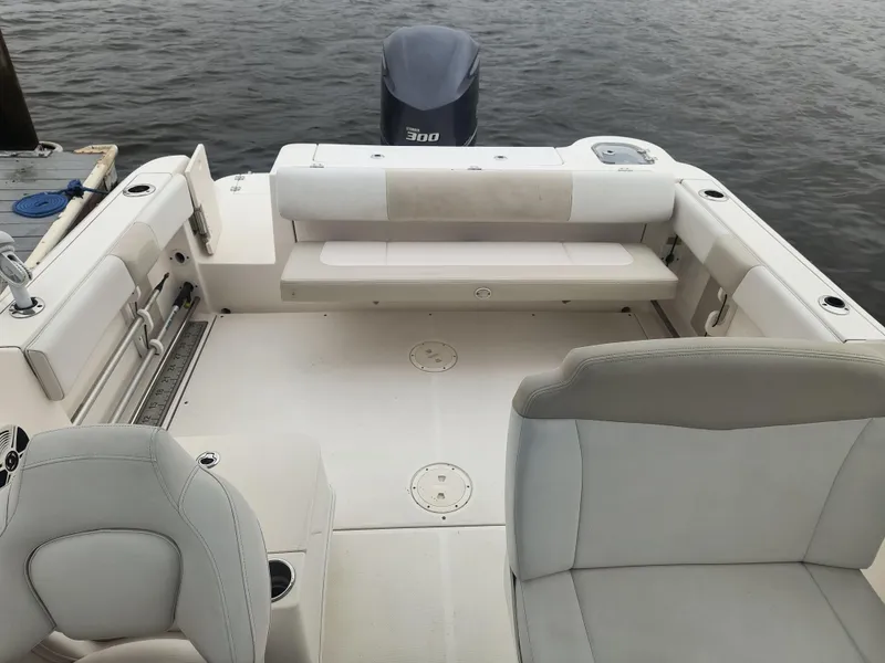 Slide: The Image of 2016 Robalo R247 Dual Console boat interior with seating and outboard motor. - 9