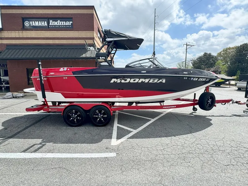 Slide: The Image of 2021 Moomba Mojo boat on red trailer, parked outside Yamaha Indmar building. - 0
