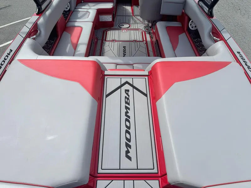 Slide: The Image of 2021 Moomba Mojo boat interior with red and gray seating and flooring. - 12