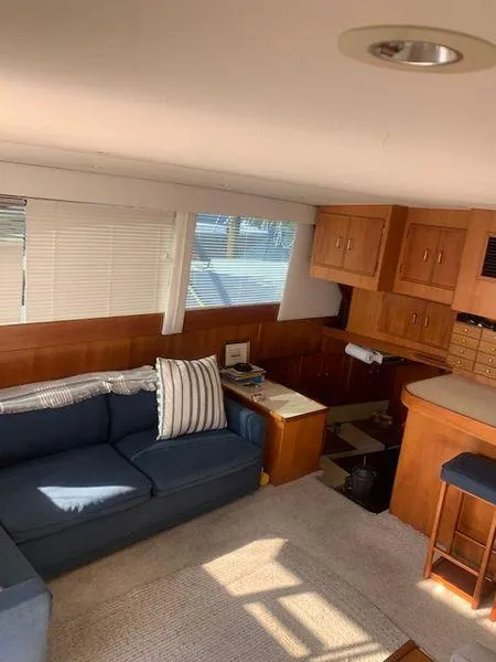 Slide: The Image of 1984 Post Convertible interior with blue sofa, wooden cabinets, and natural light. Great deal! - 11