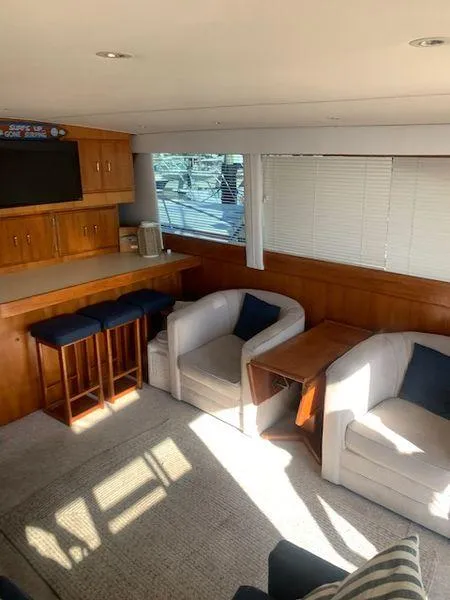 Slide: The Image of 1984 Post Convertible yacht interior with cozy seating and natural light. - 12