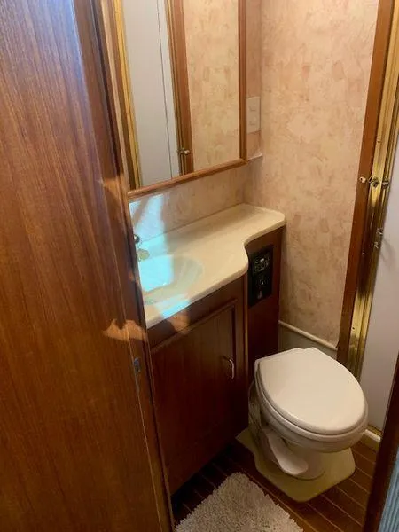 Slide: The Image of 1984 Post Convertible bathroom with wood accents and compact design. - 16