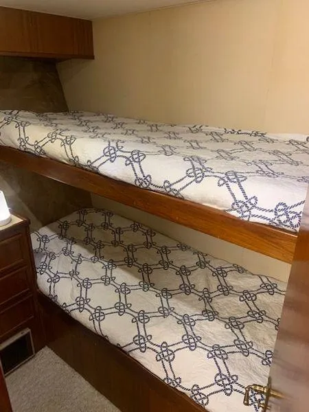 Slide: The Image of Bunk beds with patterned bedding in a 1984 Post Convertible boat interior. - 17
