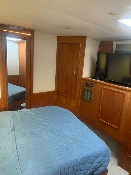 Slide: The Image of 1984 Post Convertible interior with bed, TV, and wooden cabinetry. - 19