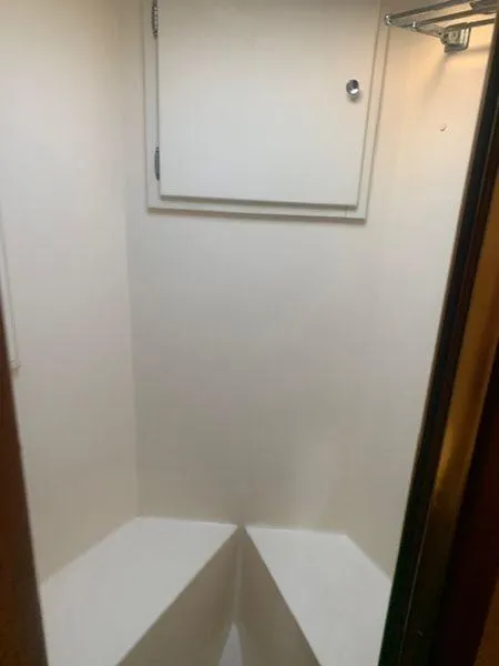 Slide: The Image of Compact white closet interior with a small storage compartment, part of a 1984 Post Convertible. - 21