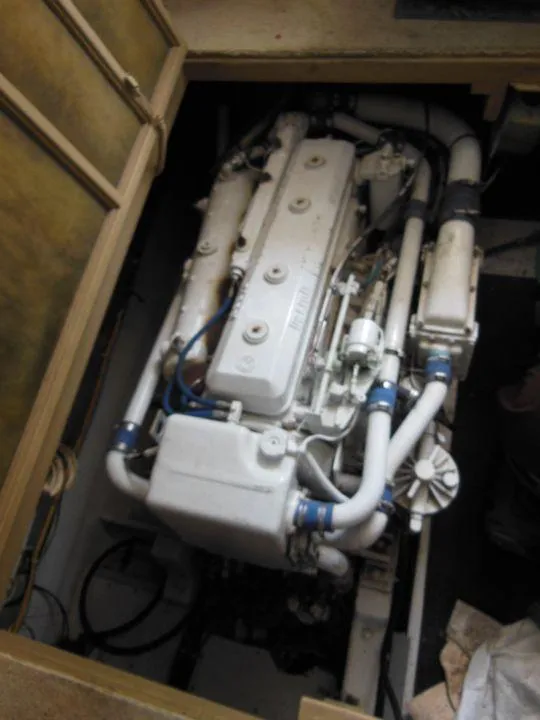 Slide: The Image of Engine compartment of a 1984 Post Convertible boat, showcasing detailed mechanical components. - 24