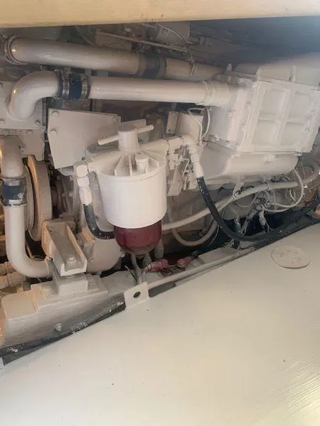 Slide: The Image of Engine compartment of a 1984 Post Convertible, showcasing mechanical components and piping. - 28