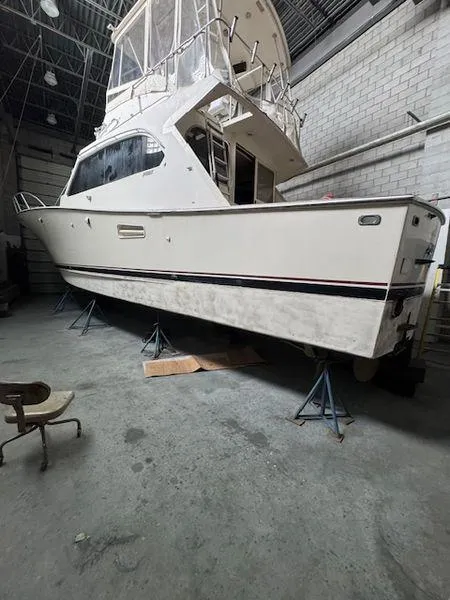 Slide: The Image of 1984 Post convertible boat in storage, elevated on stands, ready for sale. - 31