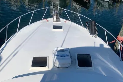 Slide: The Image of 1984 Post Convertible boat deck, white surface, docked in marina. - 9