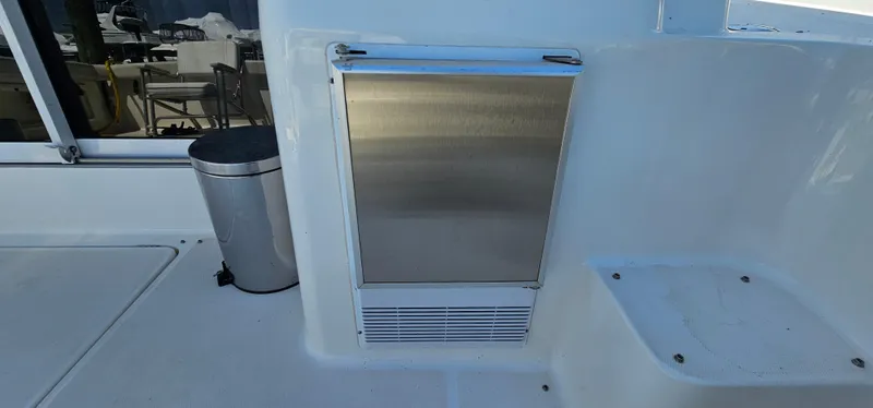 Slide: The Image of 2003 Silverton 42 Convertible boat interior with stainless steel appliance and trash bin. - 11