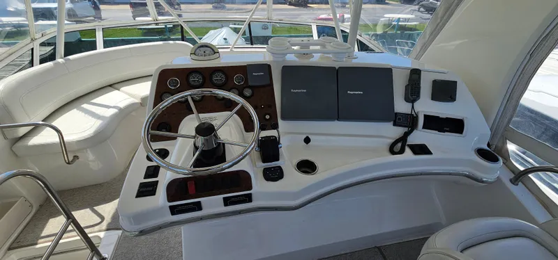 Slide: The Image of 2003 Silverton 42 Convertible yacht helm with steering wheel and navigation equipment. - 17