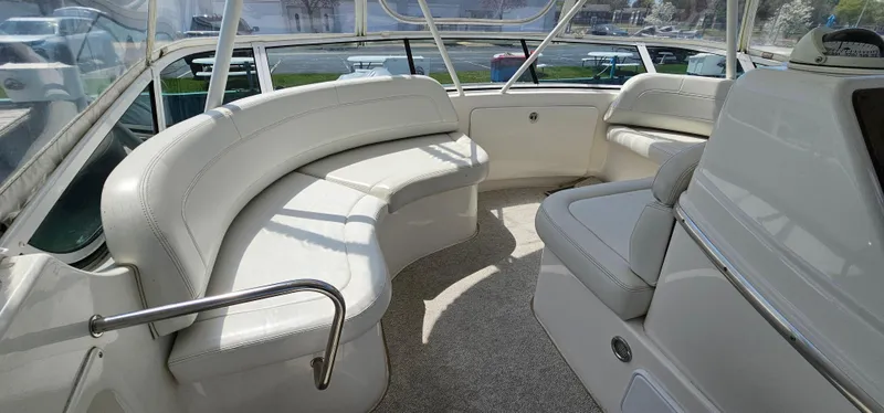 Slide: The Image of 2003 Silverton 42 Convertible yacht interior with white seating and carpeted floor. - 18