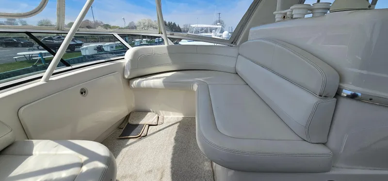 Slide: The Image of 2003 Silverton 42 Convertible yacht interior with white leather seating and panoramic windows. - 19