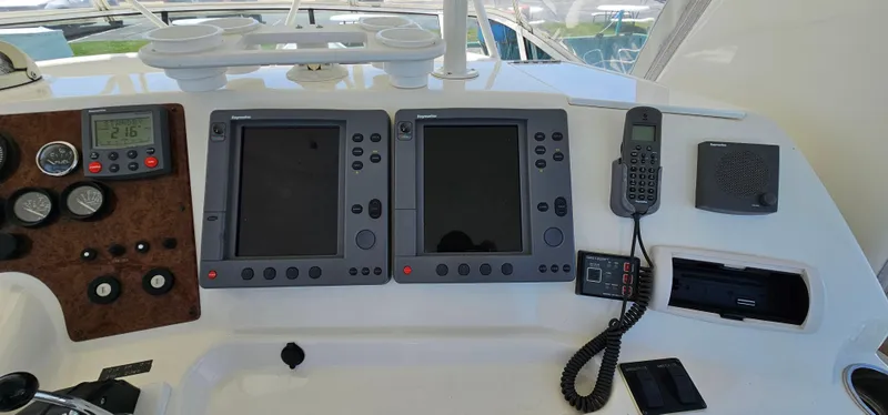 Slide: The Image of 2003 Silverton 42 Convertible yacht dashboard with navigation screens and communication equipment. - 23