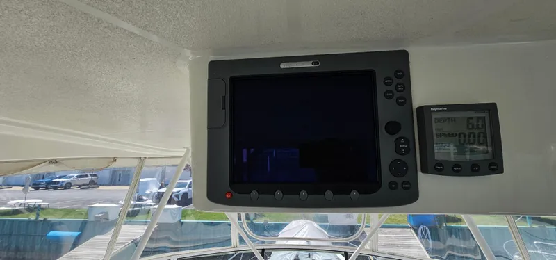 Slide: The Image of 2003 Silverton 42 Convertible boat dashboard with navigation and control screens. - 25