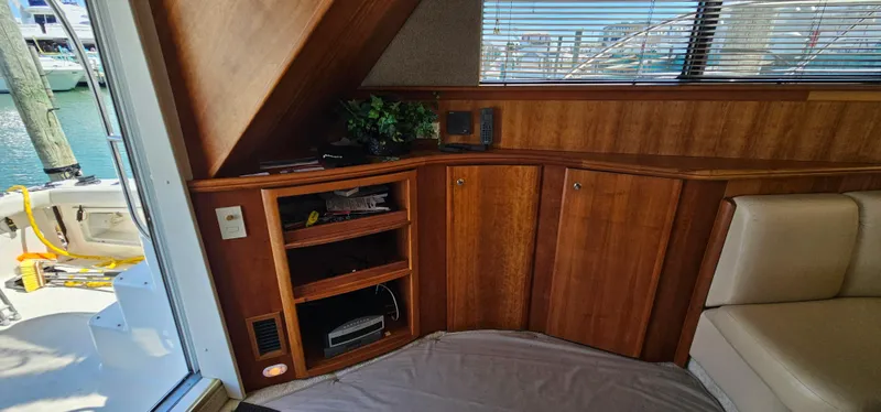 Slide: The Image of Interior of 2003 Silverton 42 Convertible yacht with wooden cabinetry and seating. - 30