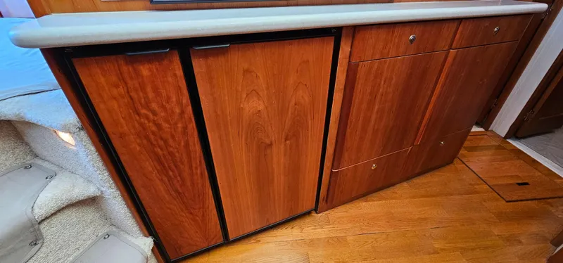 Slide: The Image of Wooden cabinetry inside a 2003 Silverton 42 Convertible yacht, featuring sleek design and ample storage. - 35