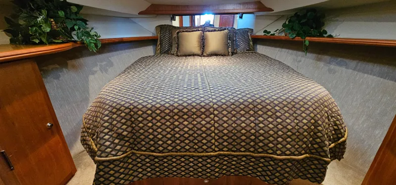 Slide: The Image of Luxurious bedroom interior of 2003 Silverton 42 Convertible yacht with elegant bedding. - 38